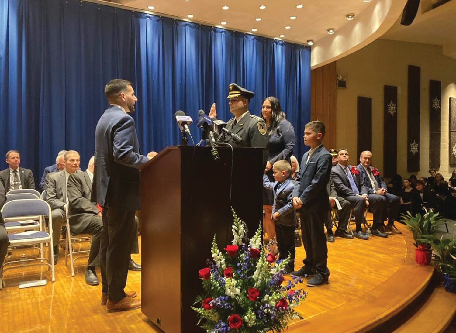 NEW CHIEF: Former Johnston Police Deputy Chief Mark A. Vieira was promoted to Police Chief Monday night. His family accompanied him on stage for his swearing-in. The auditorium was packed with the Ocean State’s top law enforcement officials, and nearly the entire JPD rank and file.
